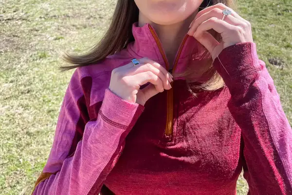 Person unzipping Smartwool Classic Thermal Merino Base Layer 1/4 Zip.