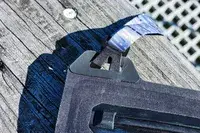 A close-up of the strap of the Nite Ize RunOff Waterproof Phone Case on wood