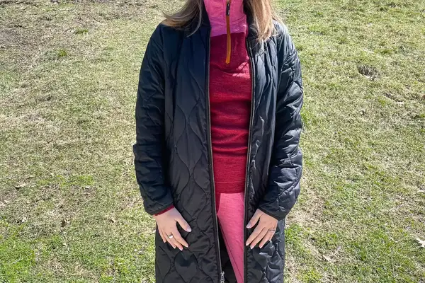 Person wearing jacket over Smartwool Classic Thermal Merino Base Layer 1/4 Zip.