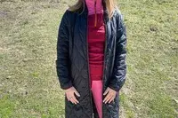 Person wearing jacket over Smartwool Classic Thermal Merino Base Layer 1/4 Zip.