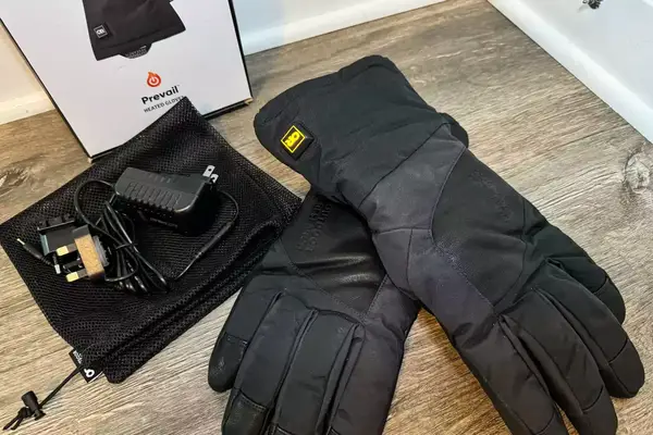 The Outdoor Research Prevail Heated GORE-TEX Gloves with accessories and box