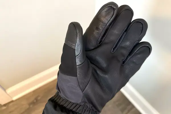 A person wears the Outdoor Research Prevail Heated GORE-TEX Gloves