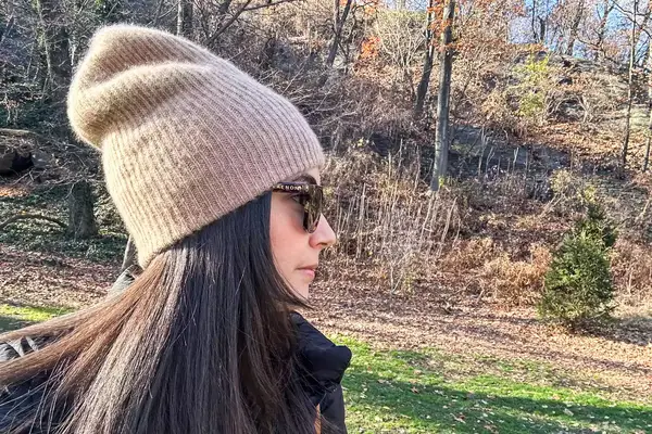 Side view of a person wearing the White + Warren Cashmere Beanie outsides