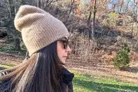 Side view of a person wearing the White + Warren Cashmere Beanie outsides