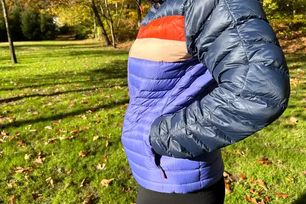 A person putting their hand in the pocket of the Cotopaxi Women