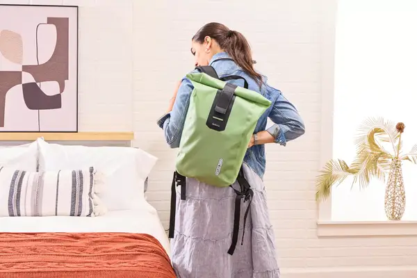 A person puts on the Ortlieb Velocity PS Pack 17L