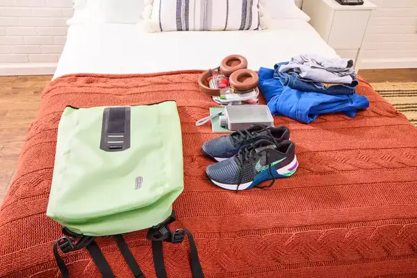 The Ortlieb Velocity PS Pack 17L on a bed with travel items