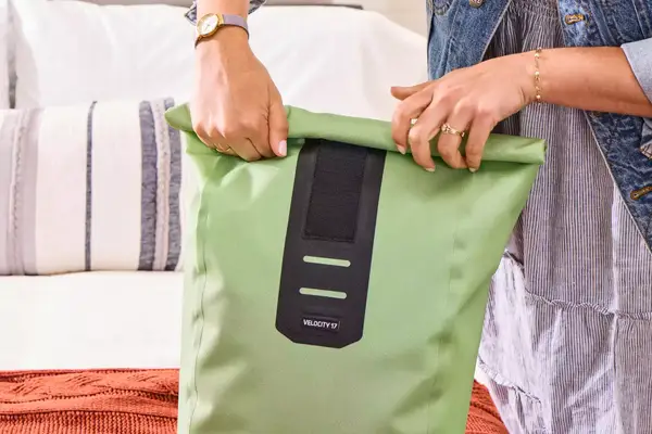 A person rolls the top of the Ortlieb Velocity PS Pack 17L