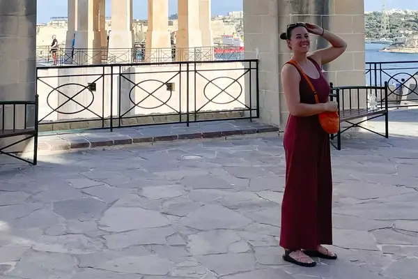 Person wearing the Imbodhi jumpsuit on a cobblestone veranda