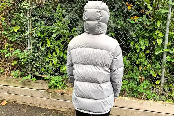 The back of a person wearing the Quince Responsible Down Long Puffer Jacket