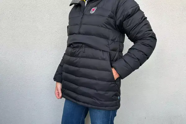 A person with their hands in their pockets while wearing the Fjallraven Expedition Pack Down Anorak