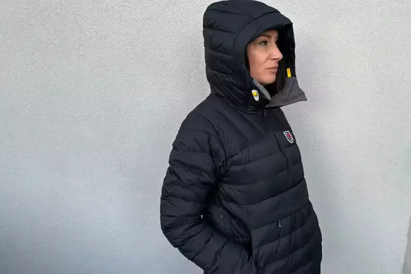 A person facing to the side while wearing the Fjallraven Expedition Pack Down Anorak