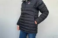 A person with their hands in their pockets while wearing the Fjallraven Expedition Pack Down Anorak