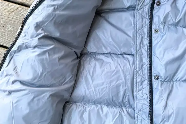 The inside of the Quince Responsible Down Long Puffer Jacket