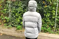 The back of a person wearing the Quince Responsible Down Long Puffer Jacket