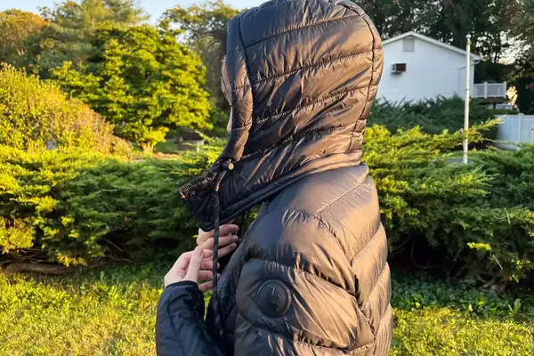 A close-up of a person wearing the Lole Claudia Down Jacket with the hood up