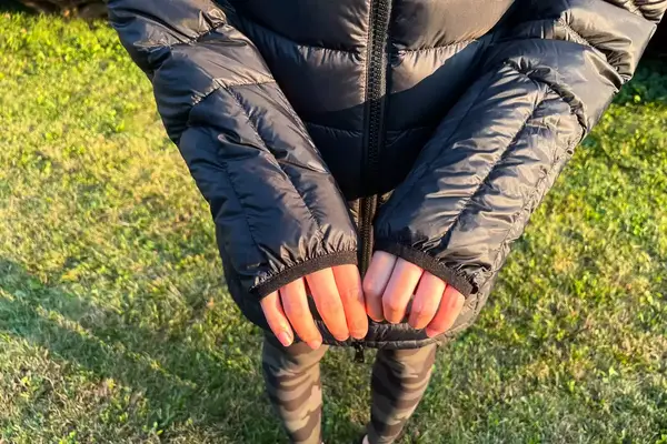 A close-up of the sleeves worn outdoors of the Lole Claudia Down Jacket