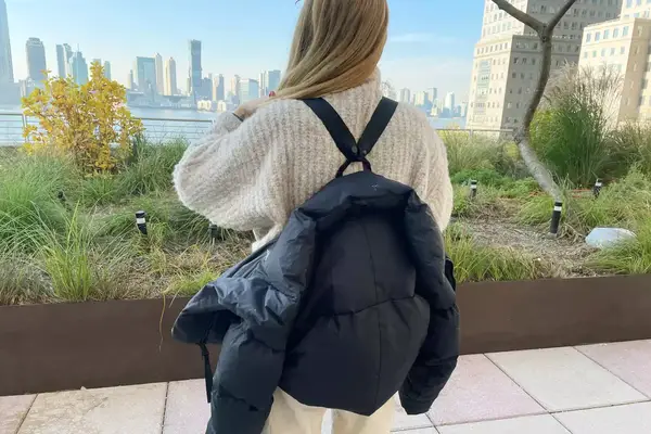 Woman wearing Canada Goose Garnet Cropped Puffer as a backpack