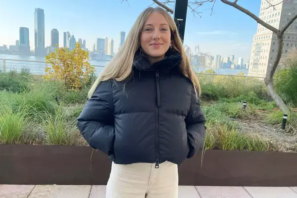 A person wearing the Canada Goose Garnet Cropped Puffer Jacket