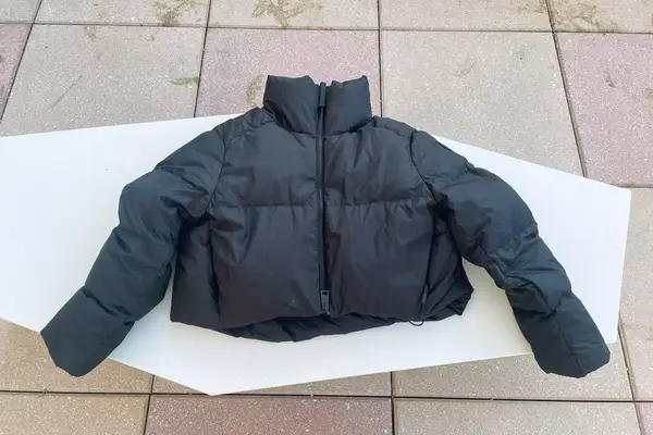 The Canada Goose Garnet Cropped Puffer Jacket displayed on pavers