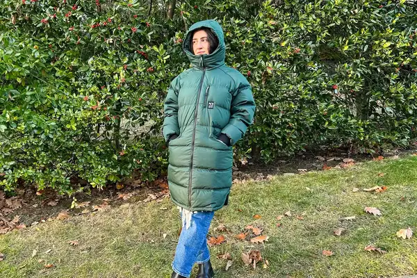 A person wears a Kari Traa Rongve Parka with the hood up