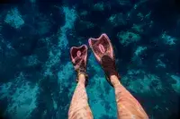 Underwater photo of feet with flippers on them taken with DJI Osmo Action 4