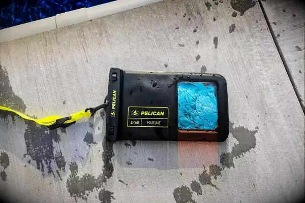 A wet Case-Mate Pelican Marine IP68 Waterproof Phone Pouch on concrete