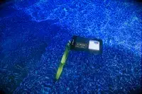 A phone in the Case-Mate Pelican Marine IP68 Waterproof Phone Pouch submerged in a pool