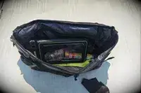 The Case-Mate Pelican Marine IP68 Waterproof Phone Pouch in a bag resting on concrete