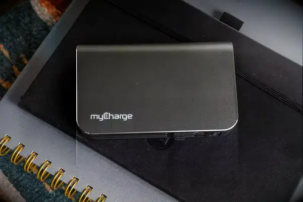 The myCharge Fast Charging Portable Charger on a notebook