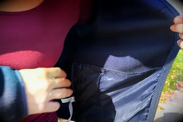 Person showing the inside of a pocket on a Cotopaxi Women