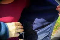 Person showing the inside of a pocket on a Cotopaxi Women