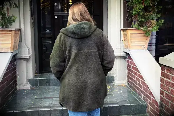 Person walking up the stairs wearing a Helly Hansen Womenâs Maud Fleece Jacket Zip Jacket