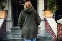 Person walking up the stairs wearing a Helly Hansen Womenâs Maud Fleece Jacket Zip Jacket