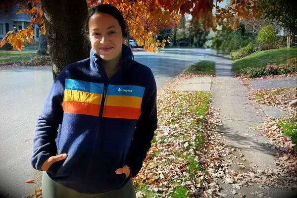 A person standing outside wearing a Cotopaxi Women’s Teca Fleece Full-zip Jacket