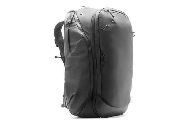 Close-up of hands unbuckling the Kühl Eskape 25 Backpack