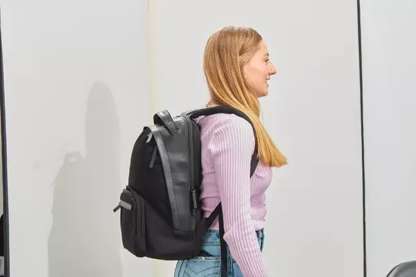 Person wearing the Troubadour Orbis 1-Pocket Backpack and facing to the side