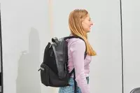 Person wearing the Troubadour Orbis 1-Pocket Backpack and facing to the side