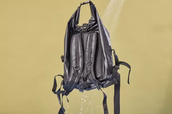 The Earth Pak Summit Dry Bag Backpack is sprayed with water