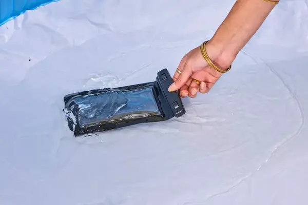 The Earth Pak Summit Dry Bag Backpack bag is dipped in water