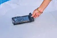 The Earth Pak Summit Dry Bag Backpack bag is dipped in water