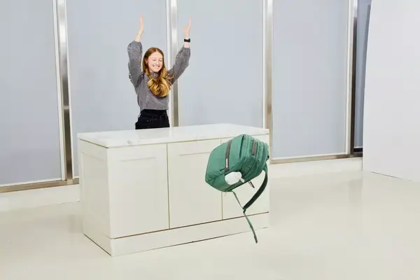 A person pushing the Samsonite Elevation Plus Backpack off of a counter