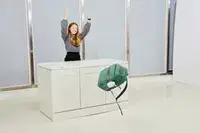 A person pushing the Samsonite Elevation Plus Backpack off of a counter