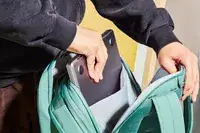 Hands placing a laptop into the Samsonite Elevation Plus Backpack