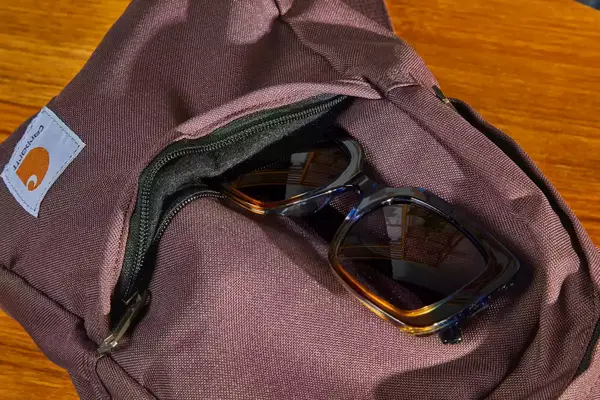 A person prepares to pack the Cotopaxi Allpa 42L Travel Pack