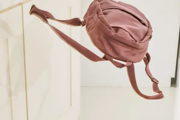 A person packs clothing into the Cotopaxi Allpa 42L Travel Pack