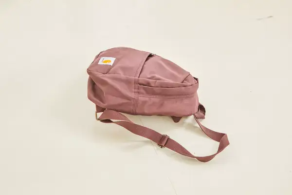 A person adjusts the straps on the Cotopaxi Allpa 42L Travel Pack