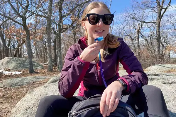 Person sitting on a rock outside with the Gregory Women