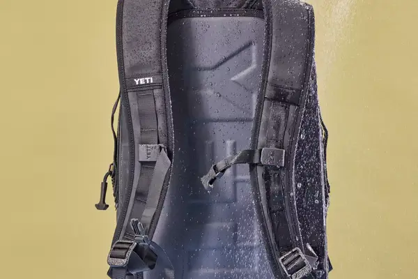 The Yeti Panga 28L Waterproof Backpack is sprayed with water