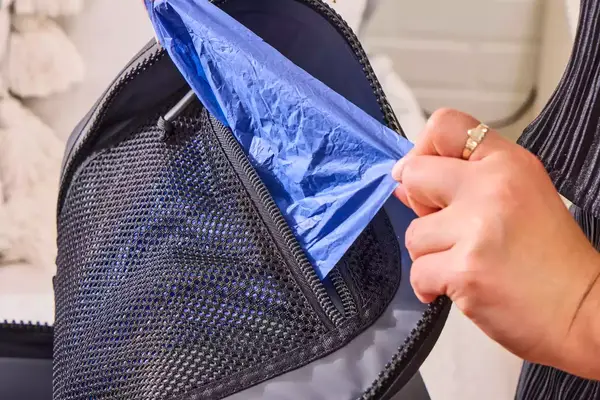 A person removes a storage bag from the Yeti Panga 28L Waterproof Backpack